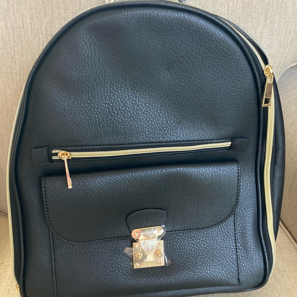 Black backpack with gold trim